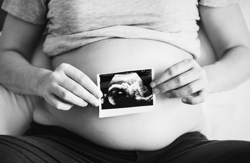 future mom holding ultrasound photo