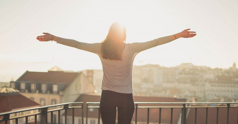 women embracing sunset