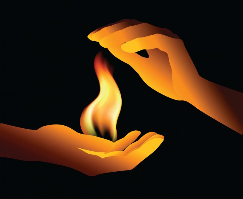 two hands holding a flame