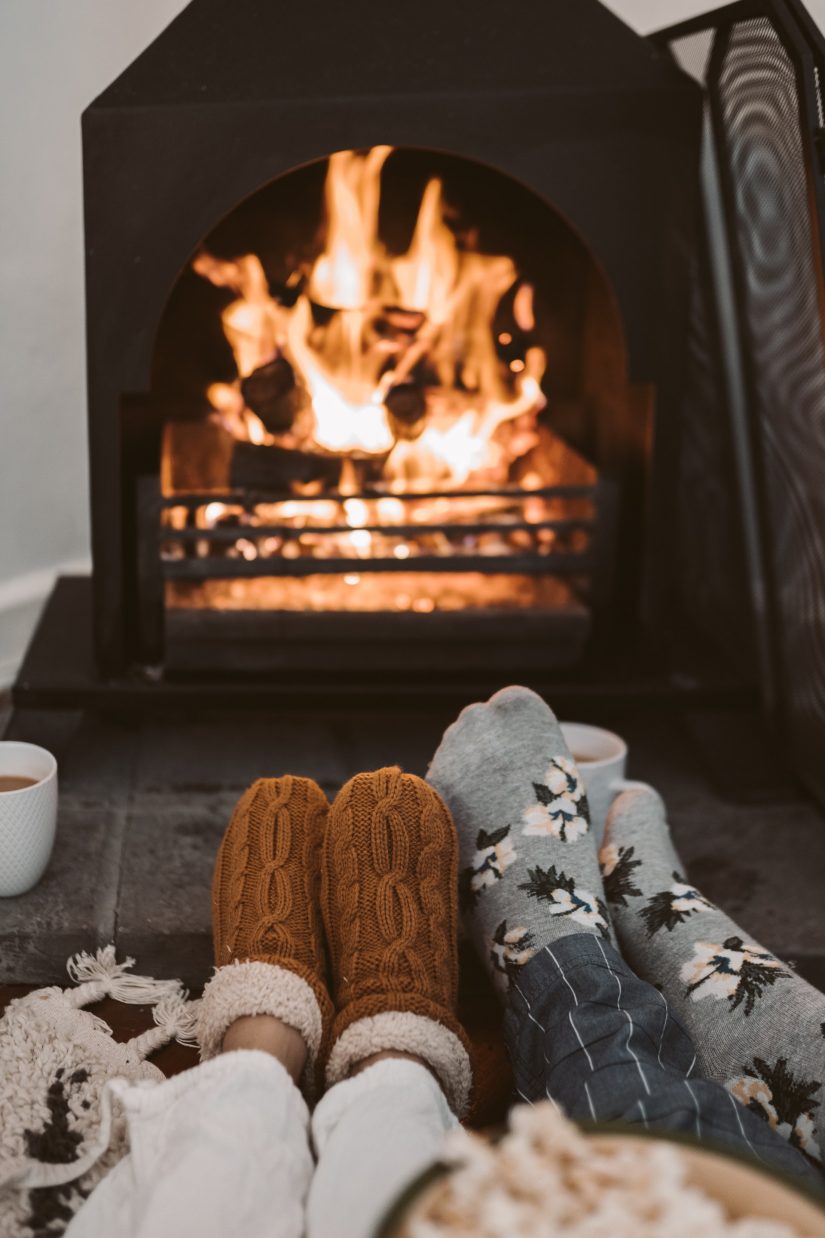 couple sitting by fireplace