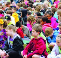 crowd of children doing yoga